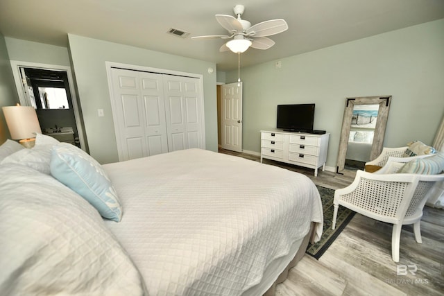 bedroom with a closet, ceiling fan, and light wood-type flooring