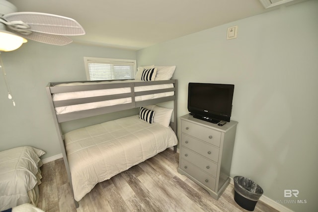 bedroom with ceiling fan and hardwood / wood-style flooring