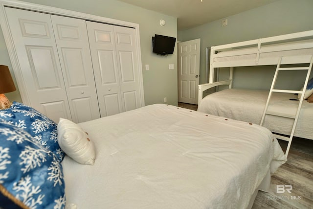 bedroom featuring dark hardwood / wood-style flooring and a closet