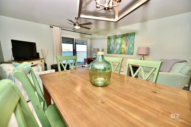 dining room with ceiling fan with notable chandelier