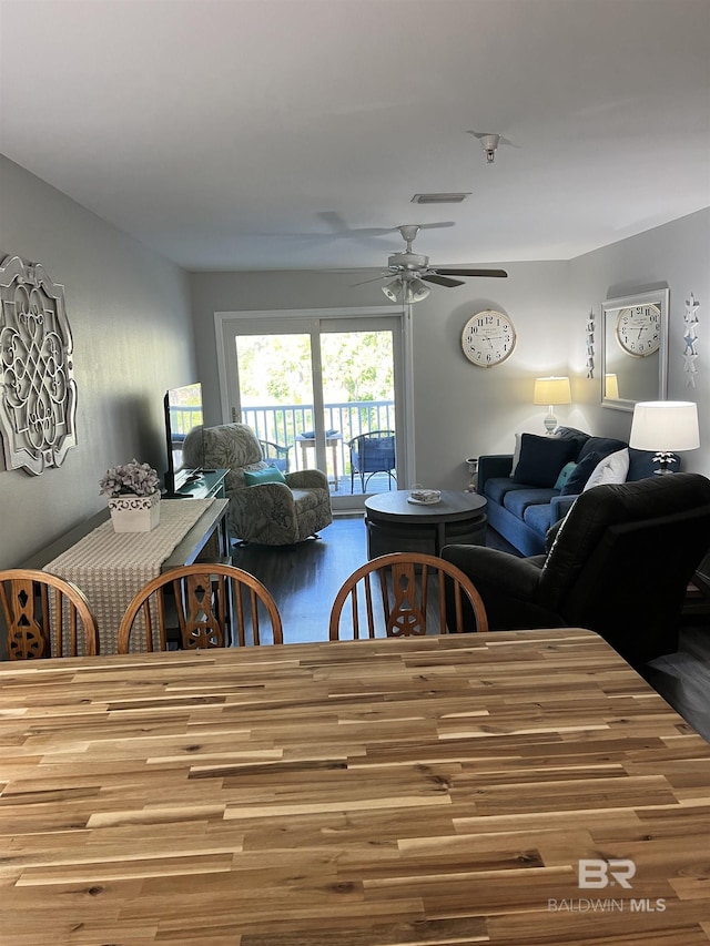 dining area with ceiling fan, wood finished floors, and visible vents