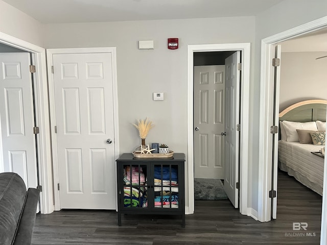 bedroom with dark wood-style flooring