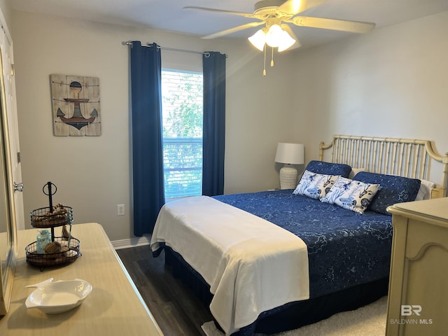 bedroom featuring dark wood-style flooring and a ceiling fan