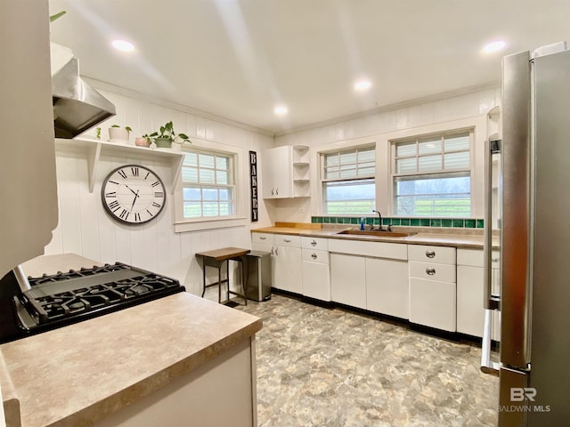 kitchen featuring open shelves, freestanding refrigerator, a sink, white cabinets, and crown molding