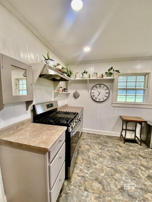 kitchen featuring under cabinet range hood, ornamental molding, gas stove, white cabinetry, and open shelves