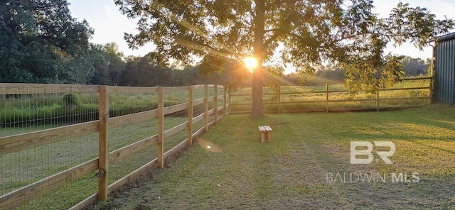 view of yard featuring a rural view and a fenced backyard