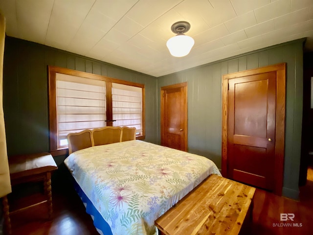 bedroom with dark wood-type flooring