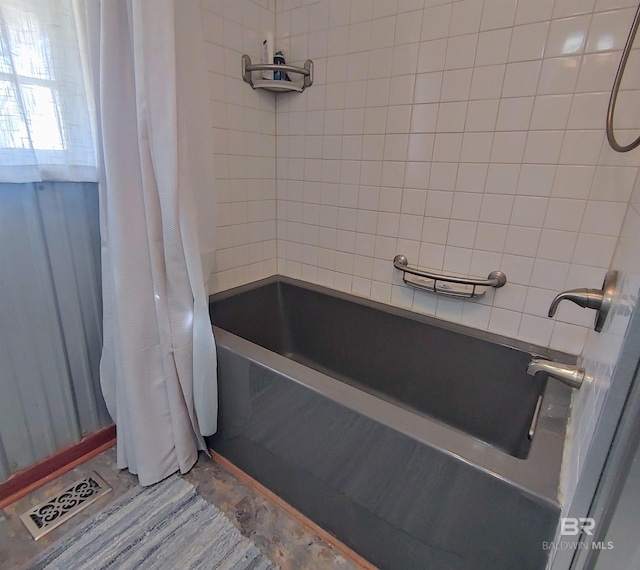 full bathroom with visible vents and shower / bathtub combination with curtain