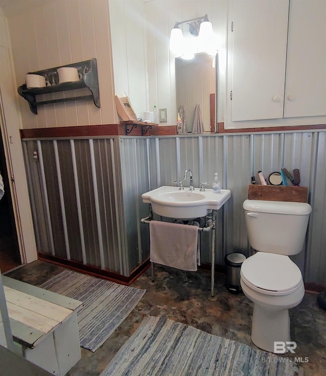 half bathroom with toilet and a sink