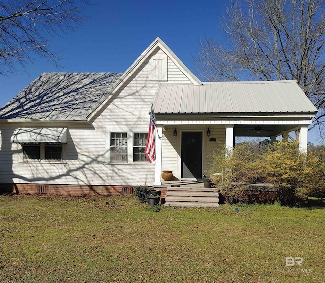 view of front of home with crawl space, covered porch, a front lawn, and metal roof