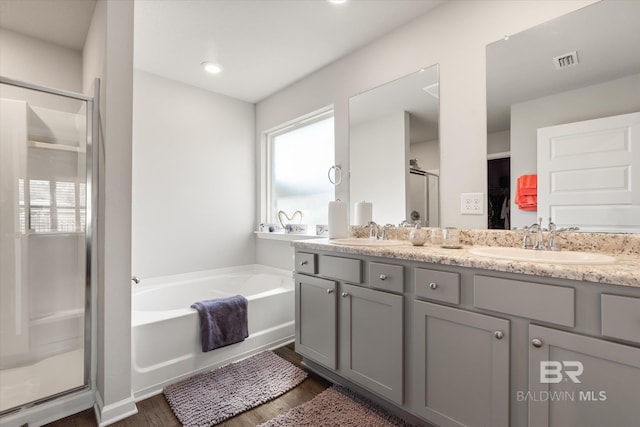 bathroom featuring a wealth of natural light, hardwood / wood-style flooring, vanity, and independent shower and bath