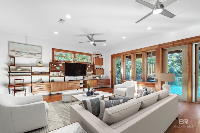 living room with recessed lighting, plenty of natural light, and wood finished floors