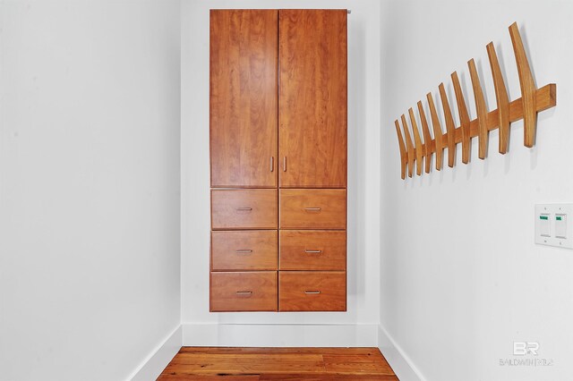 details featuring baseboards and wood finished floors