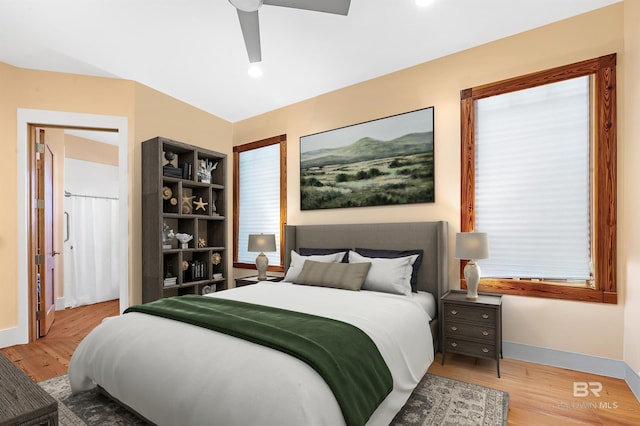 bedroom featuring ceiling fan, baseboards, and wood finished floors