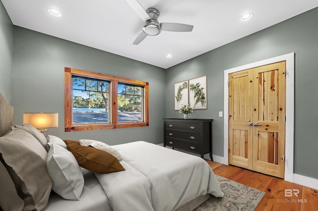 bedroom with recessed lighting, wood finished floors, and baseboards