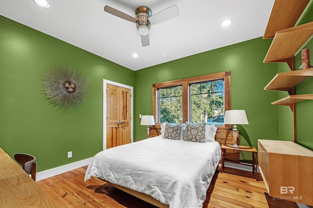 bedroom with a ceiling fan, baseboards, wood finished floors, and recessed lighting