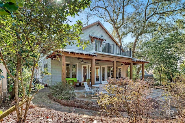 rear view of house with a patio area, ceiling fan, and french doors