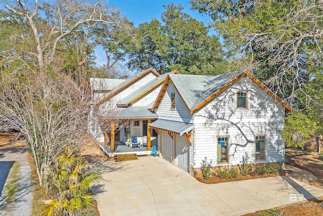 view of front of home with metal roof and driveway