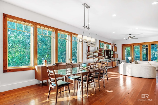 dining space with a healthy amount of sunlight, hardwood / wood-style flooring, and recessed lighting