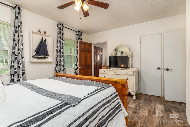 bedroom featuring ceiling fan, dark hardwood / wood-style floors, and crown molding