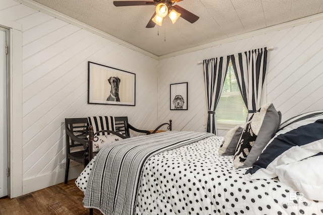 bedroom featuring wood-type flooring, ornamental molding, and ceiling fan