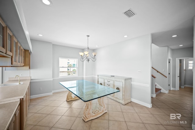 2024 W Beach Blvd, Gulf Shores, AL 36542 - dining room featuring a chandelier, light tile patterned flooring, stairs, and recessed lighting