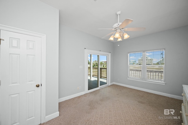 2024 W Beach Blvd, Gulf Shores, AL 36542 - carpeted spare room featuring baseboards and a ceiling fan