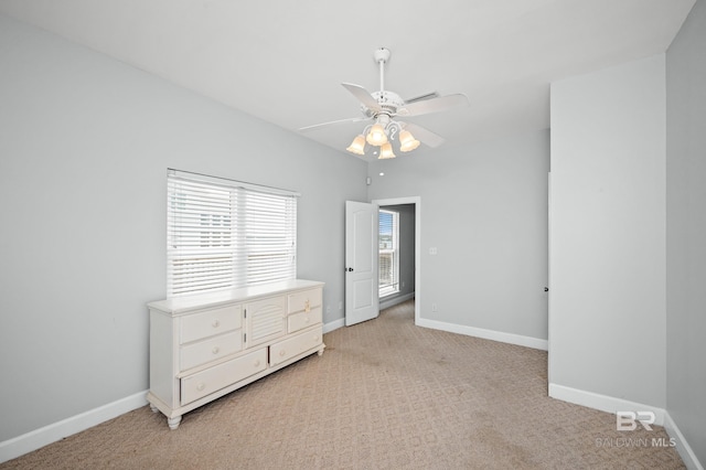 2024 W Beach Blvd, Gulf Shores, AL 36542 - unfurnished bedroom featuring light carpet and a ceiling fan