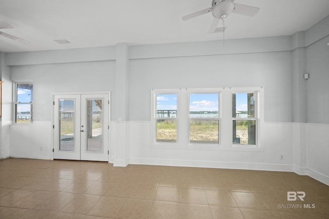 2024 W Beach Blvd, Gulf Shores, AL 36542 - tiled empty room featuring a ceiling fan, plenty of natural light, and french doors