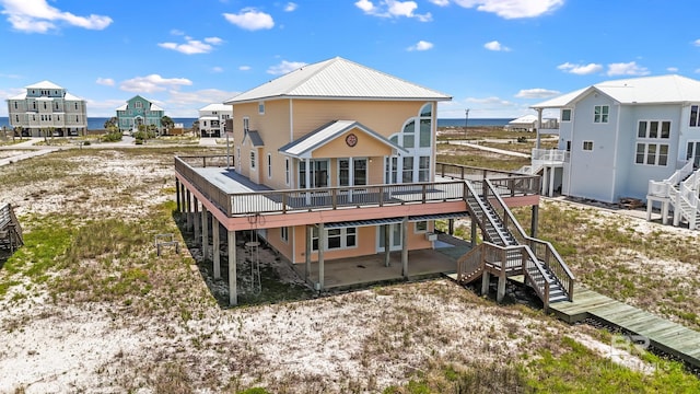 2024 W Beach Blvd, Gulf Shores, AL 36542 - rear view of property featuring stairs, a deck, and a patio area