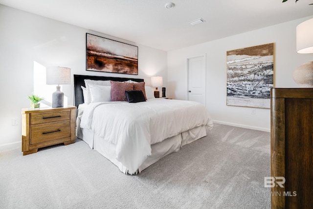 bedroom with baseboards and light colored carpet