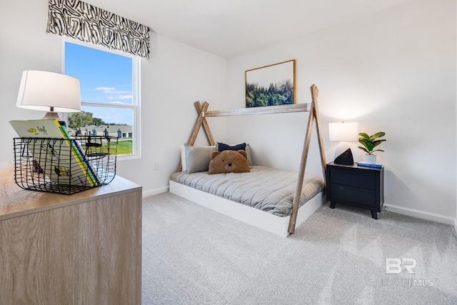 bedroom featuring carpet and baseboards