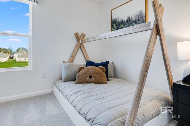 carpeted bedroom featuring baseboards