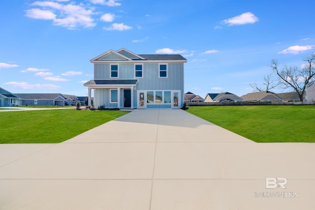 view of front of house featuring board and batten siding, a front yard, roof with shingles, and a residential view