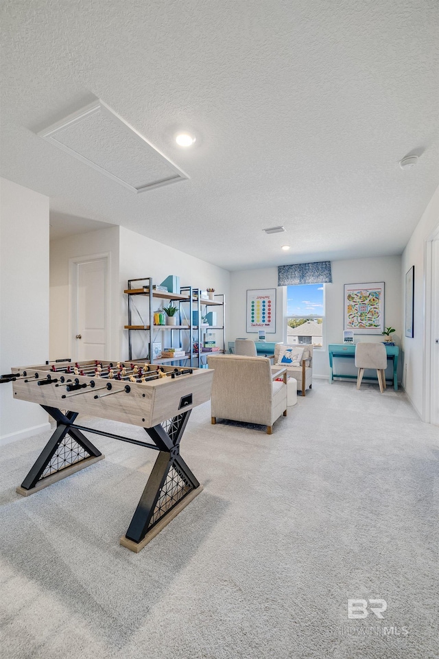 carpeted living room featuring a textured ceiling and baseboards