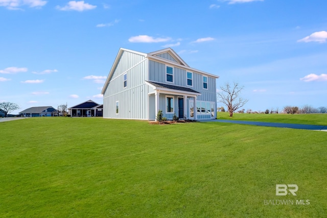 view of front of home with a porch, a front lawn, and board and batten siding