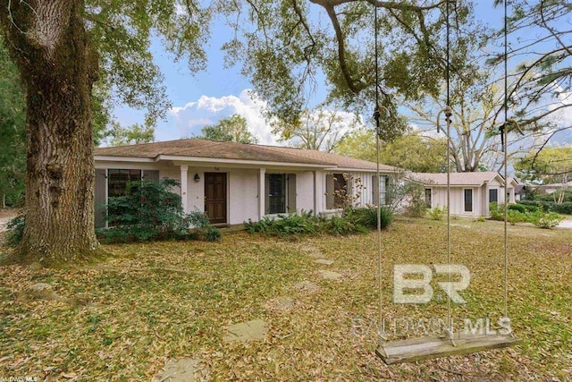 ranch-style home with a front lawn