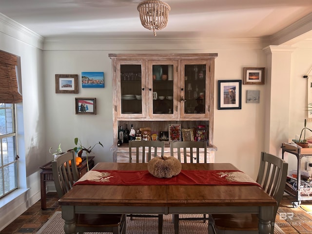 dining area featuring a notable chandelier and ornamental molding