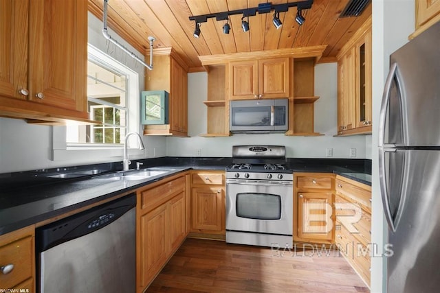 kitchen with dark wood-type flooring, track lighting, sink, appliances with stainless steel finishes, and wood ceiling