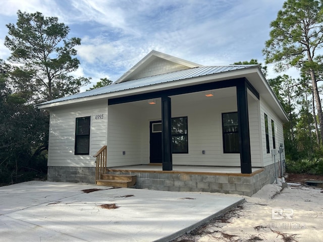 view of front of property with a porch and metal roof