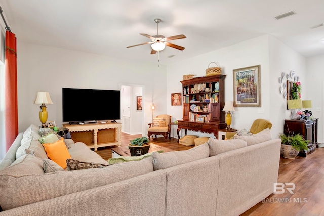 living room featuring hardwood / wood-style floors and ceiling fan