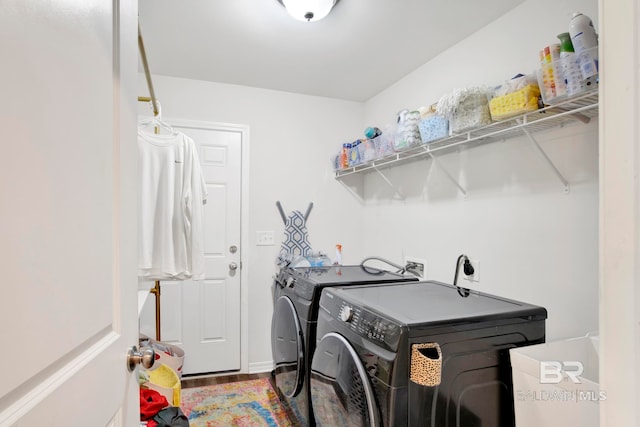 laundry room with washer and dryer and hardwood / wood-style floors