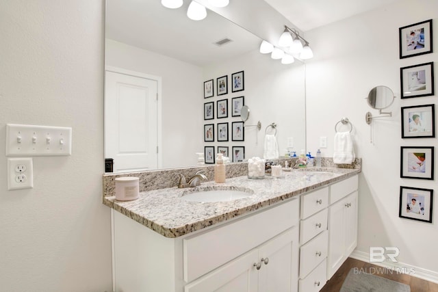 bathroom with vanity and hardwood / wood-style floors