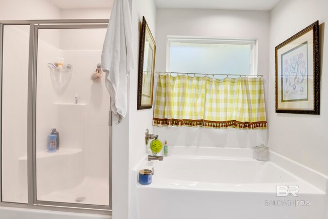 bathroom with shower with separate bathtub