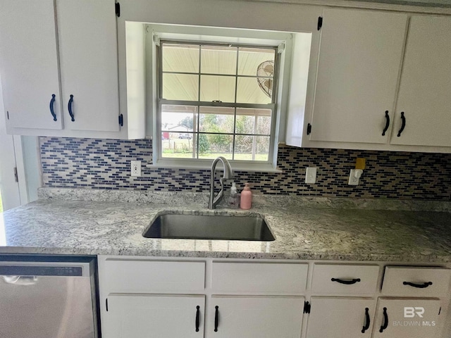 kitchen featuring sink, dishwasher, backsplash, light stone countertops, and white cabinets