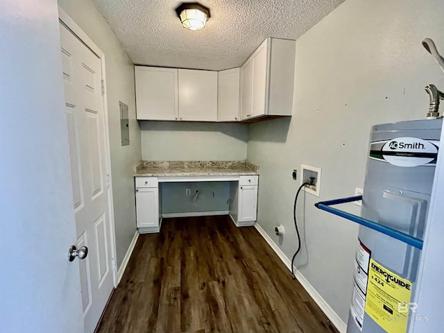 clothes washing area featuring water heater, electric dryer hookup, cabinets, a textured ceiling, and dark hardwood / wood-style flooring