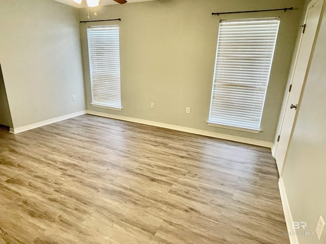 empty room featuring light hardwood / wood-style flooring and ceiling fan