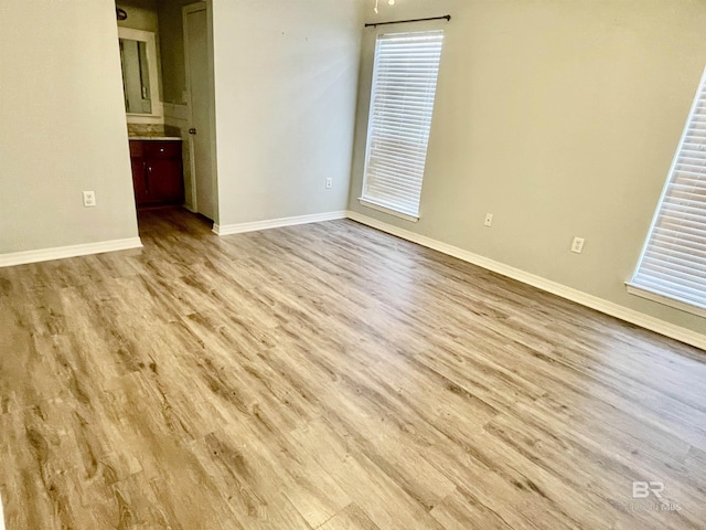 unfurnished room with light wood-type flooring