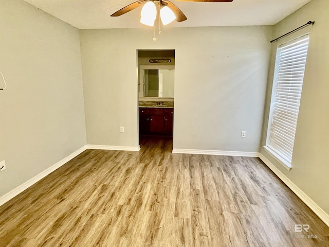 unfurnished bedroom with light hardwood / wood-style flooring and ceiling fan