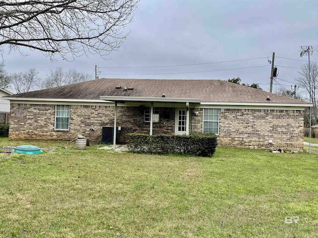 rear view of house featuring a lawn